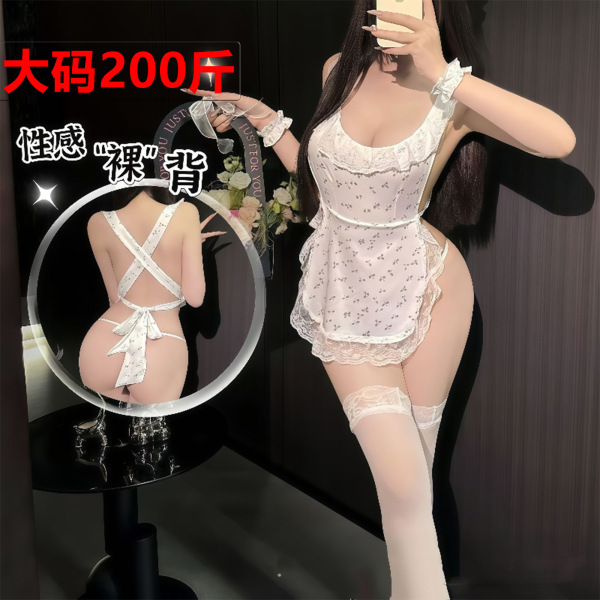 Woman modeling sexy lace backless maid costume with sheer apron, cheeky cutout, and white thigh-high stockings.