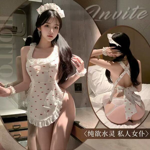 Woman modeling a white cherry print maid costume featuring a sexy backless apron design with cheeky cut-outs and sheer lace t...