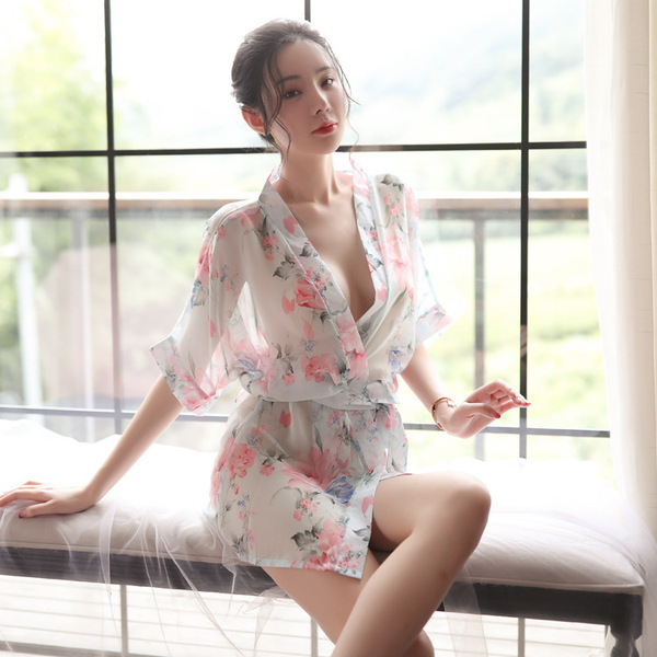 A woman poses elegantly in a japanese-style sleepwear set featuring sheer chiffon lace, with floral patterns on the kimono ro...