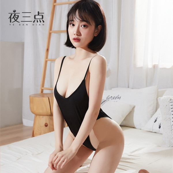 Woman wearing black suoqing ice silk swimsuit lingerie - sexy 72d tight-fit cooling summer bodysuit, posing on bed in bright ...