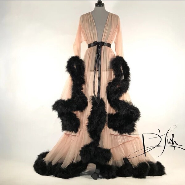 Elegant feather sleeve gown with sheer fabric and dramatic black fur-trimmed train, perfect for evening wear or sleepwear set...