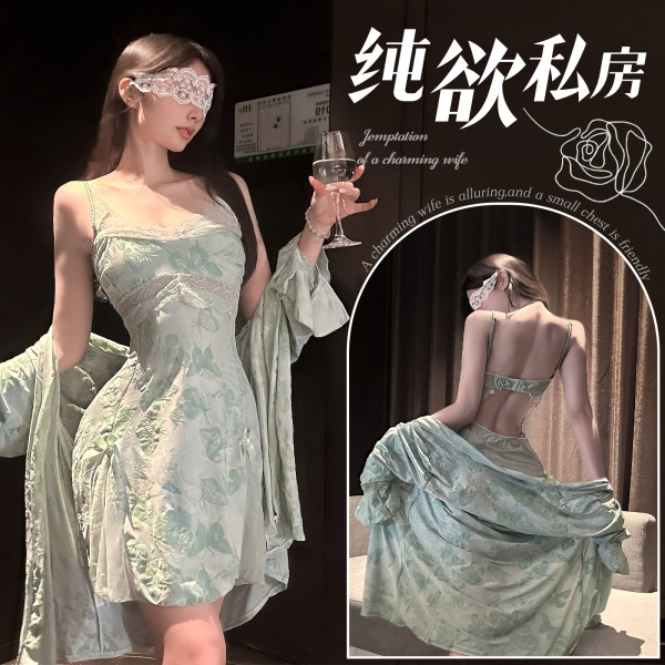 Woman wearing elegant green lace print chemise with garter belt, holding wine glass, showcasing backless design and silk feel...