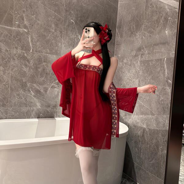 Woman in red feiniao moon-gazing hanfu lingerie set, sheer silk doudou with floral trim, posing in marble bathroom.