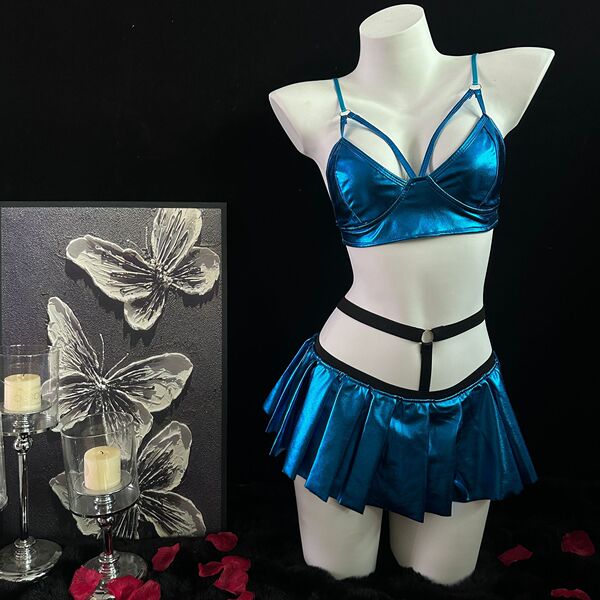 Shiny blue lingerie set with bra, pleated skirt, and black harness on mannequin.