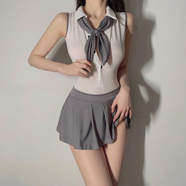Woman wearing a white backless jumpsuit with a grey tie and matching pleated skirt, styled as a cute jk schoolgirl uniform se...