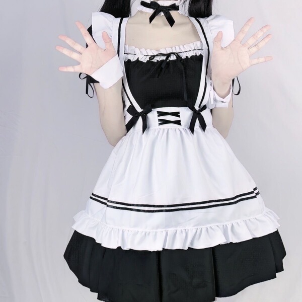 Cute maid cosplay dress featuring black and white colors, ruffled details, and bow accents, perfect for japanese lolita style...