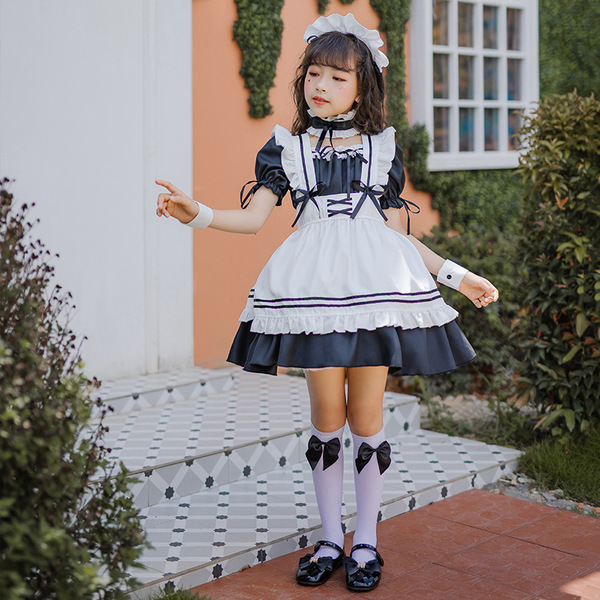 A young girl wears a japanese girl black maid dress, featuring a cute lolita princess costume with ruffled sleeves and skirt,...