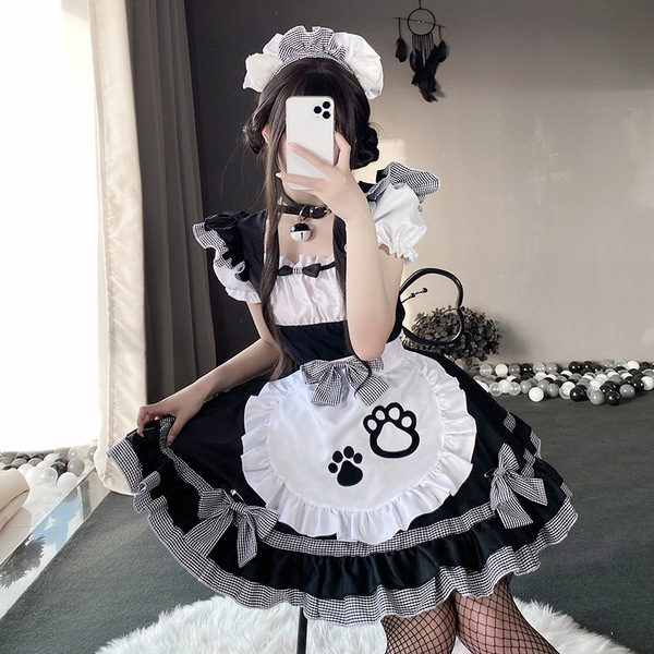 A person wearing a black and white maid costume with a fluffy apron featuring paw prints, perfect for cosplay or role play.