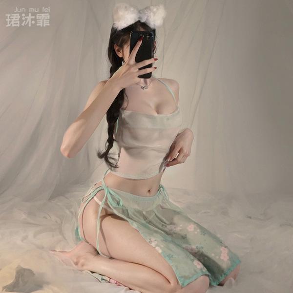 A woman poses with a smartphone, wearing an elegant ancient chinese style silk belly band bodysuit paired with a floral skirt...