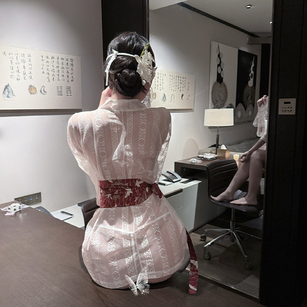 A woman sits facing away from the camera, wearing an elegant ancient chinese hanfu costume set inspired by qin-han dynasty at...