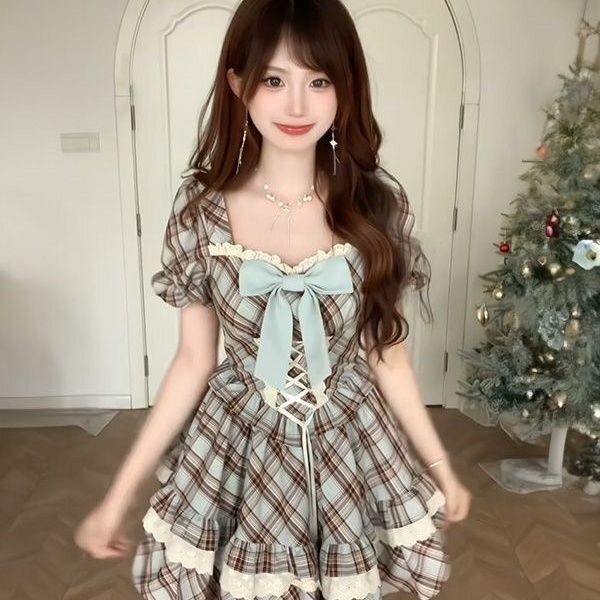 A charming woman wears a vintage-inspired plaid dress with lace detailing and a bow at the waist, perfect for summer elegance...