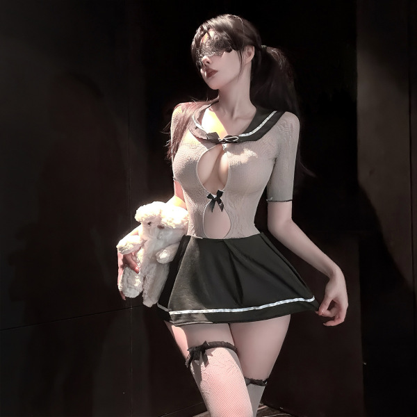 Model in chaomu jk sailor outfit with sheer mesh bodysuit, black pleated skirt, thigh-highs, and fluffy white accessory.