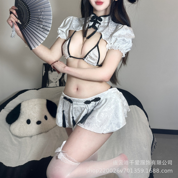 A woman poses wearing a classic chinese qipao-style lingerie set, featuring a delicate white and black design with puffed sle...