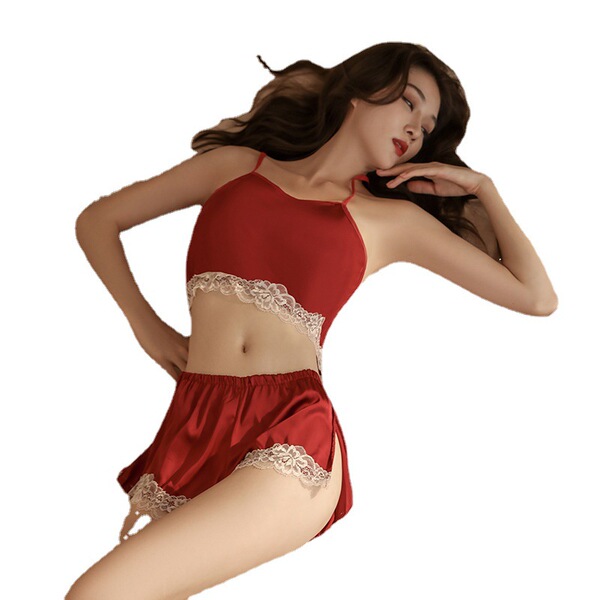 Woman modeling red lace-trimmed two-piece lingerie set, featuring a camisole top and shorts, designed for intimate moments an...