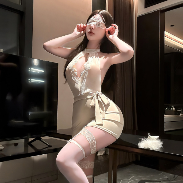 Woman modeling golden night lace lingerie set with eye mask, garter belt, and sheer stockings in elegant secretary style.