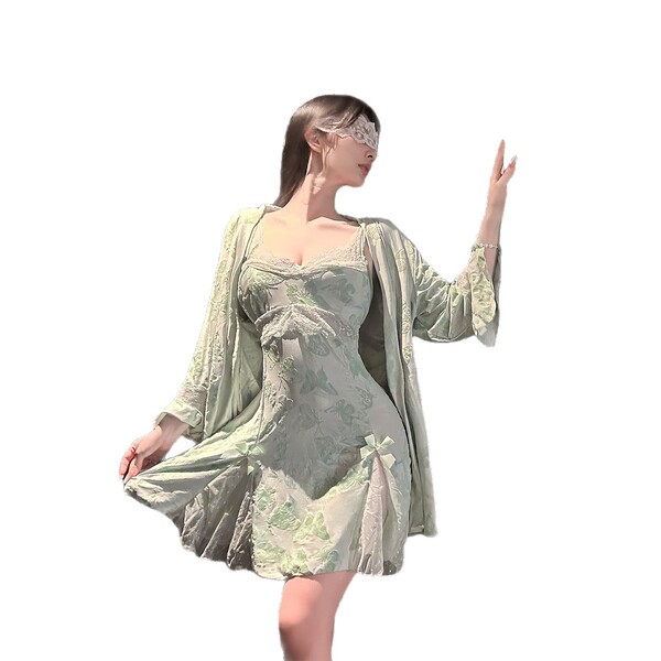Woman wearing elegant golden night lace print lingerie set with silk-feel chemise and garter belt, posing gracefully.