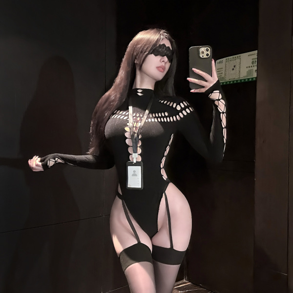 Woman in golden night seductive knit bodysuit with sheer mesh, cutouts, and thigh-highs, taking a mirror selfie.