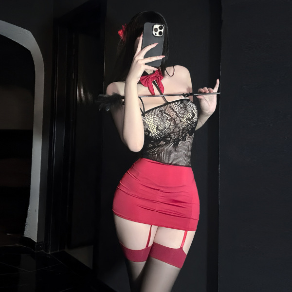 Woman in golden night sexy strapless lingerie set with red skirt, sheer top, and garter stockings posing seductively.