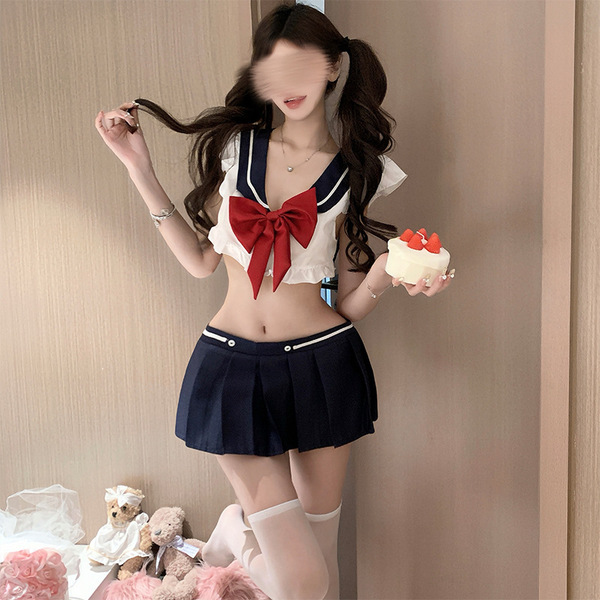 A stylish girl wearing a gufei sexy schoolgirl costume set, featuring a sailor top with a red bow, a pleated skirt, and thigh...
