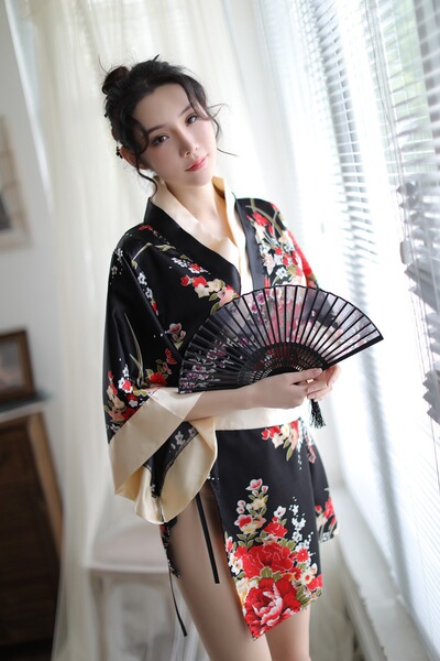 A woman poses elegantly in a japanese kimono-style lingerie set, featuring floral patterns and traditional design elements, p...