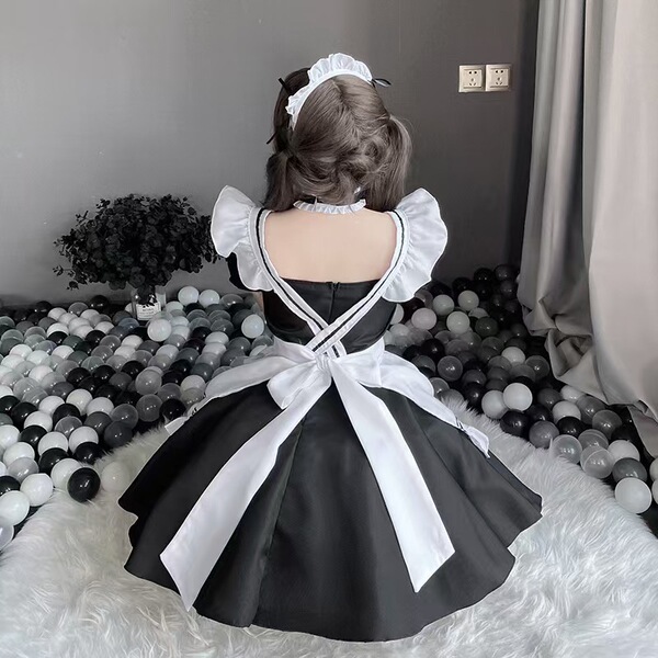 Japanese maid costume with black and white lolita dress, featuring puffy sleeves and a bow, perfect for stage performances an...