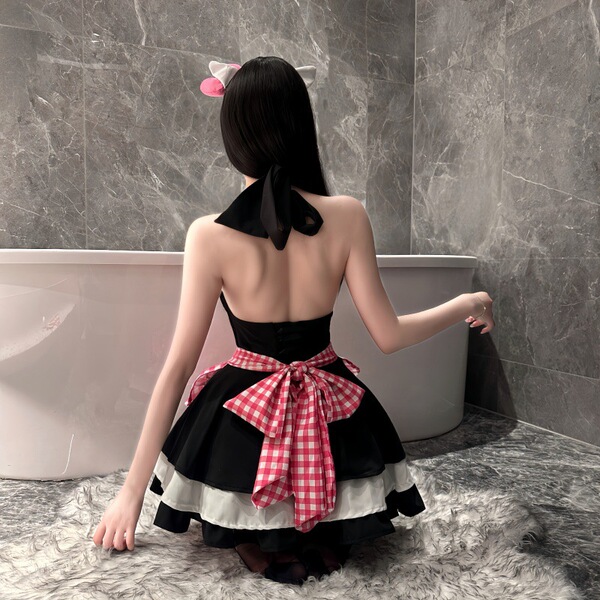 A woman wearing a black and red checkered maid costume with cat ears sits by a bathtub, showcasing a playful yet elegant desi...