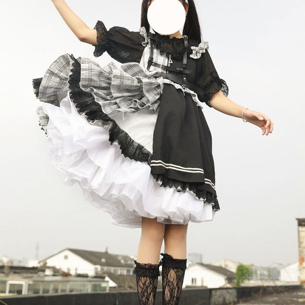 A person wearing a lolita-style dress featuring a crinoline petticoat, black lace details, and a voluminous skirt, perfect fo...