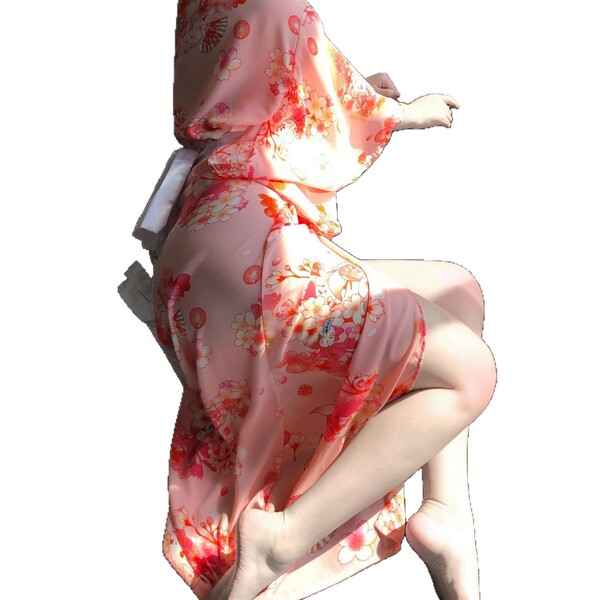 A woman wears a pink floral japanese kimono-style lingerie set, featuring long sleeves and elegant design, perfect for seduct...