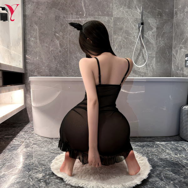 A woman poses in a luxurious bathroom wearing a black night silk sensual lace sheer dress, featuring a wire-free design and i...