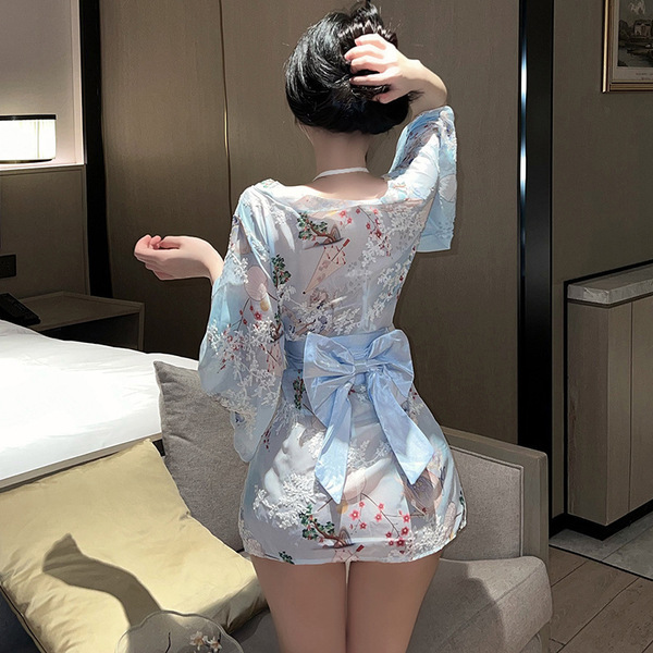 A woman stands facing away from the camera, wearing a plus-size japanese-style sexy kimono robe. the dress features a floral ...