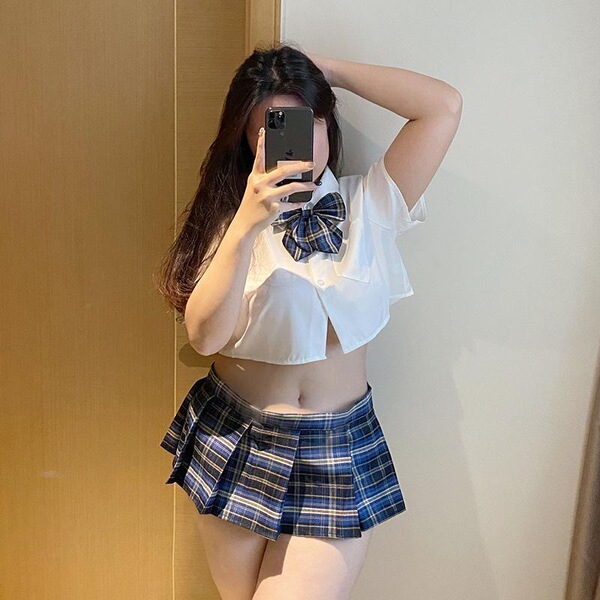 Curvy womens schoolgirl style short skirt paired with a white blouse and bow tie, perfect for cute and flirty bedroom outfits...