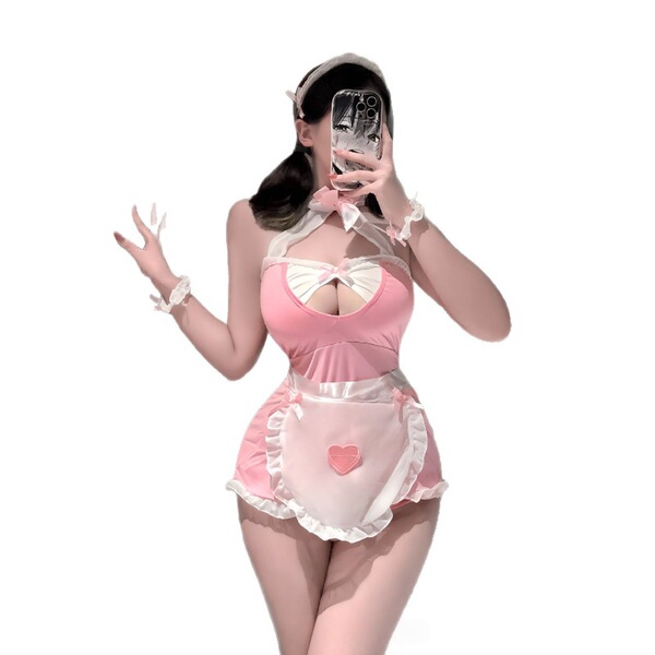 Woman in pink plus size maid costume with open-crotch design, featuring ruffled apron and heart detail for role play.