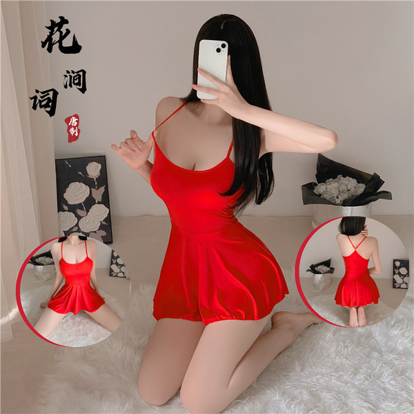 A woman poses in a red cami dress with a backless design, showcasing its sheer lace details. the dress features a scoop neckl...