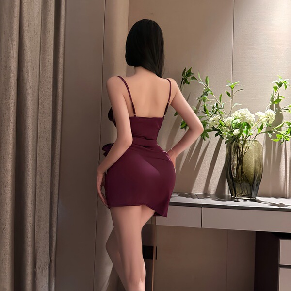 Woman wearing burgundy lace-back sleepwear set with adjustable ties, showcasing premium ice silk fabric and elegant silhouett...