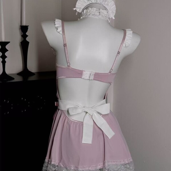 Pink lingerie set with white bow and lace trim, featuring a playful yet elegant design for seductive sleepwear.