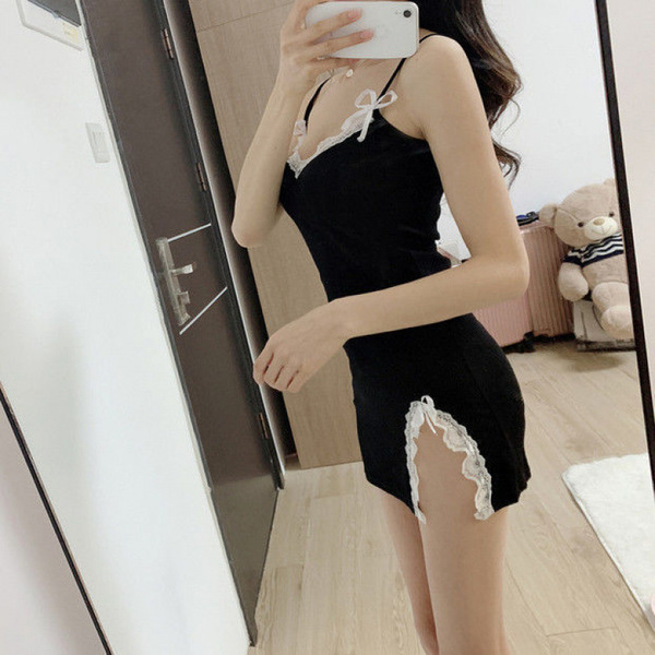 A woman poses in a black sheer sleep dress with lace details, capturing a playful yet elegant moment. the dress features deli...