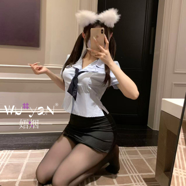 Woman kneeling in mirror selfie wearing pure & playful lingerie set – sheer white top, black skirt, cat ears, sensual qqny st...