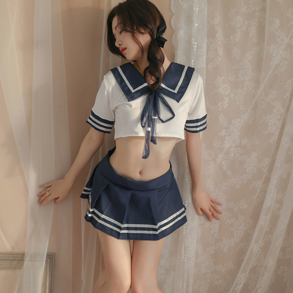 Woman wearing a blue and white sailor-style lingerie set with a crop top and pleated skirt.