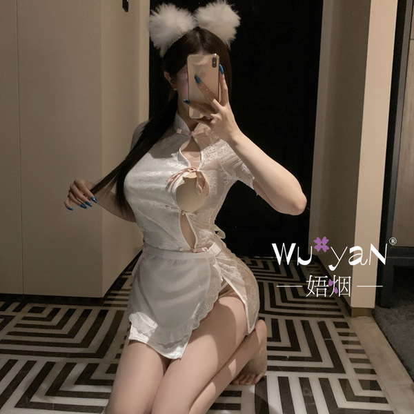 A woman poses with a smartphone, wearing a white lace qipao-inspired sleepwear set. the outfit features delicate details and ...