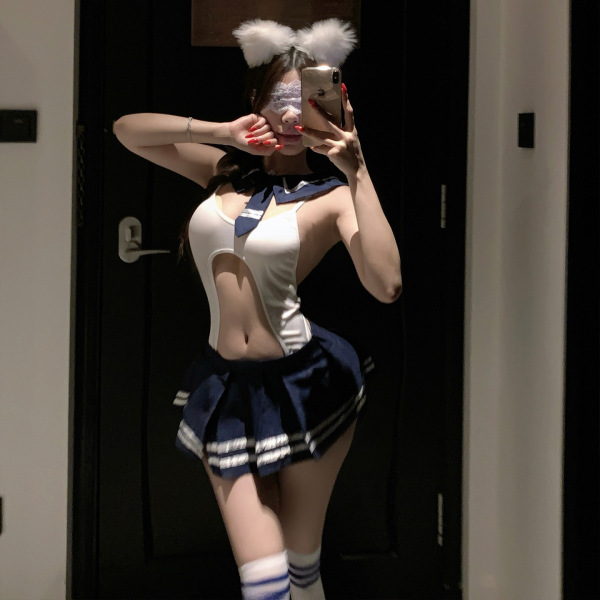 Woman in pure & seductive lingerie set, student-style with white top, navy skirt, cat ears, and thigh-high socks.
