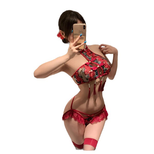 Woman modeling red sheer chinese-inspired bodysuit with floral embroidery, lace trim, and garter straps; back view holding ph...