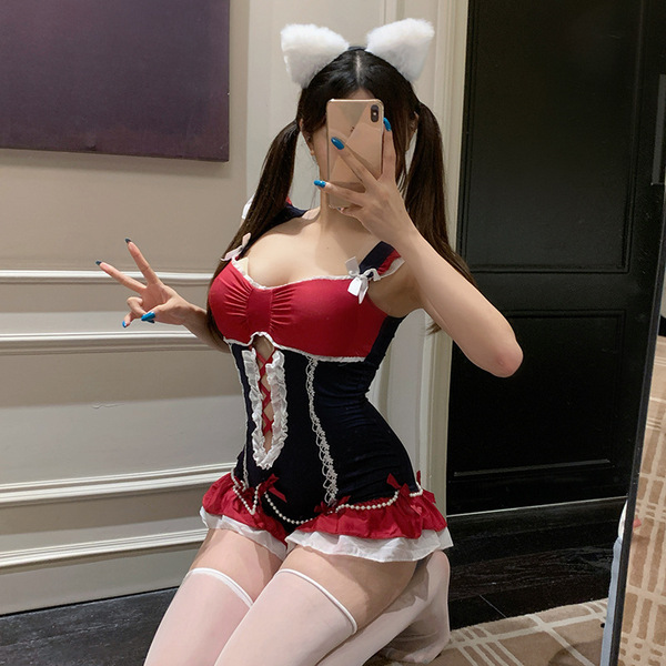 A woman poses with cat ears, wearing a red and black sheer bodysuit featuring lace details and an open crotch design, perfect...