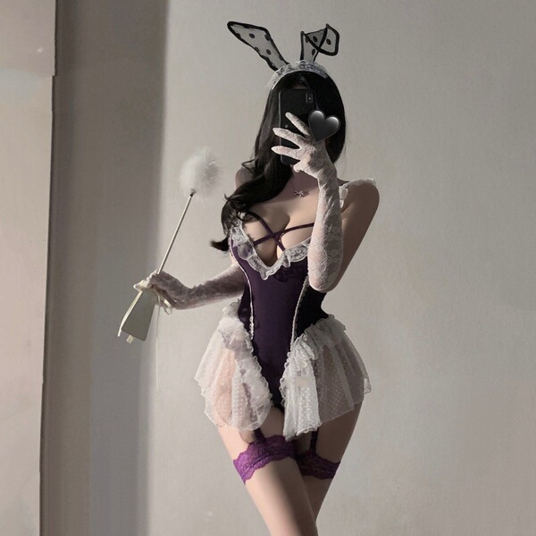 Woman wearing purple lace bodysuit with bunny ears, holding a wand—sexy lingerie set for alluring sleepwear or costume.
