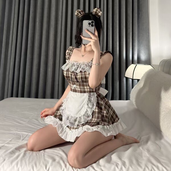 A person wearing a qiaoduo schoolgirl maid costume, featuring a plaid dress with lace trim and split-back design, sitting on ...