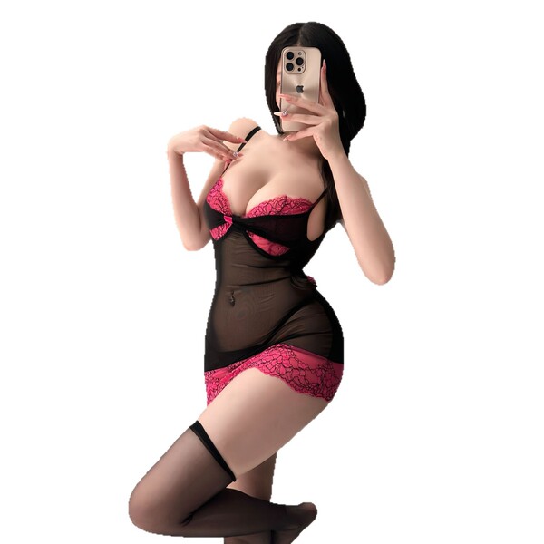 A woman poses in a black and pink lace corset dress with underwire, featuring sheer fabric and thigh-high stockings, perfect ...