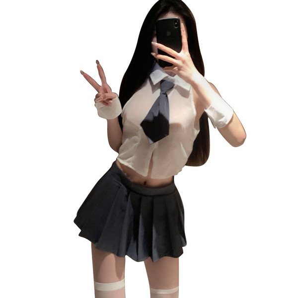 A woman poses with a phone, wearing a sheer blouse, tie, pleated skirt, and stockings, embodying a cute schoolgirl style ense...