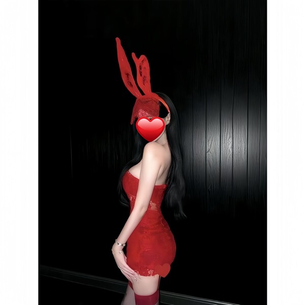 Woman wearing red bunny girl lingerie set with lace crop top, bodycon mini dress, and matching ears for christmas or cosplay.
