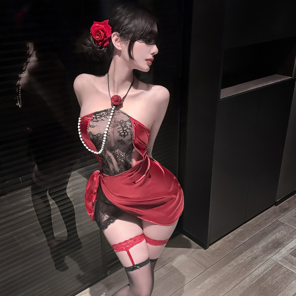 Woman wearing red rose lace lingerie set with sheer black panels, pearl necklace, and matching garter stockings.