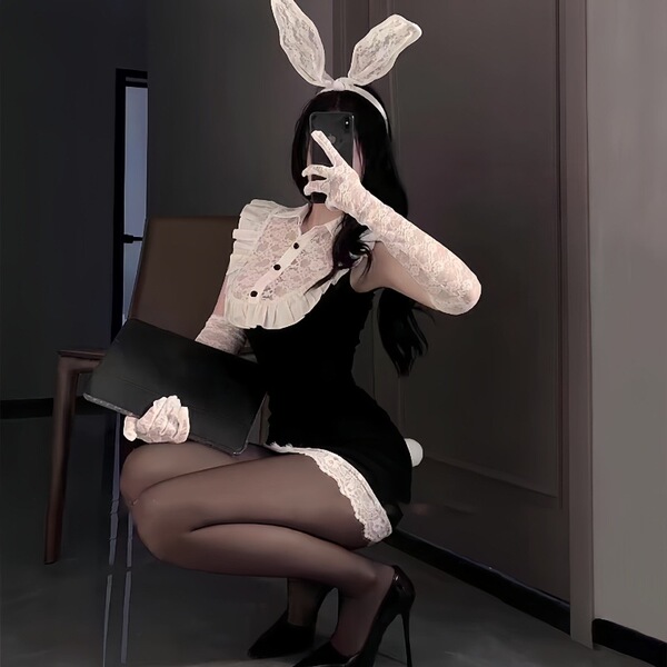 Woman in black secretary bunny girl lingerie set with lace gloves, ears, and heels, posing seductively for role play.