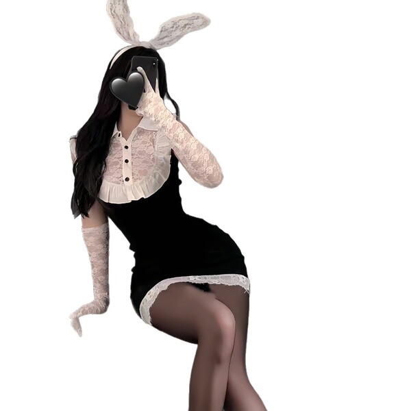 Woman in black bodycon dress with white lace trim, bunny ears, and gloves posing seductively for role play.